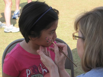 Little girl getting her face painted