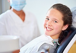 Smiling gilr in dental chair