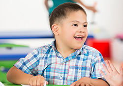 Young child smiling in classroom