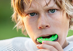 Teen boy placing sportsguard