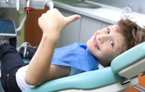 A smiling child at his dental appointment.